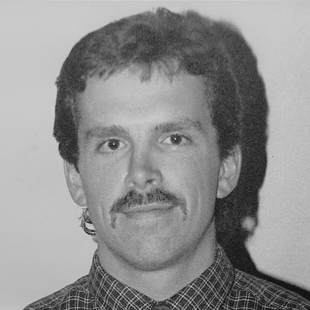 A black and white headshot of Dave Long. 